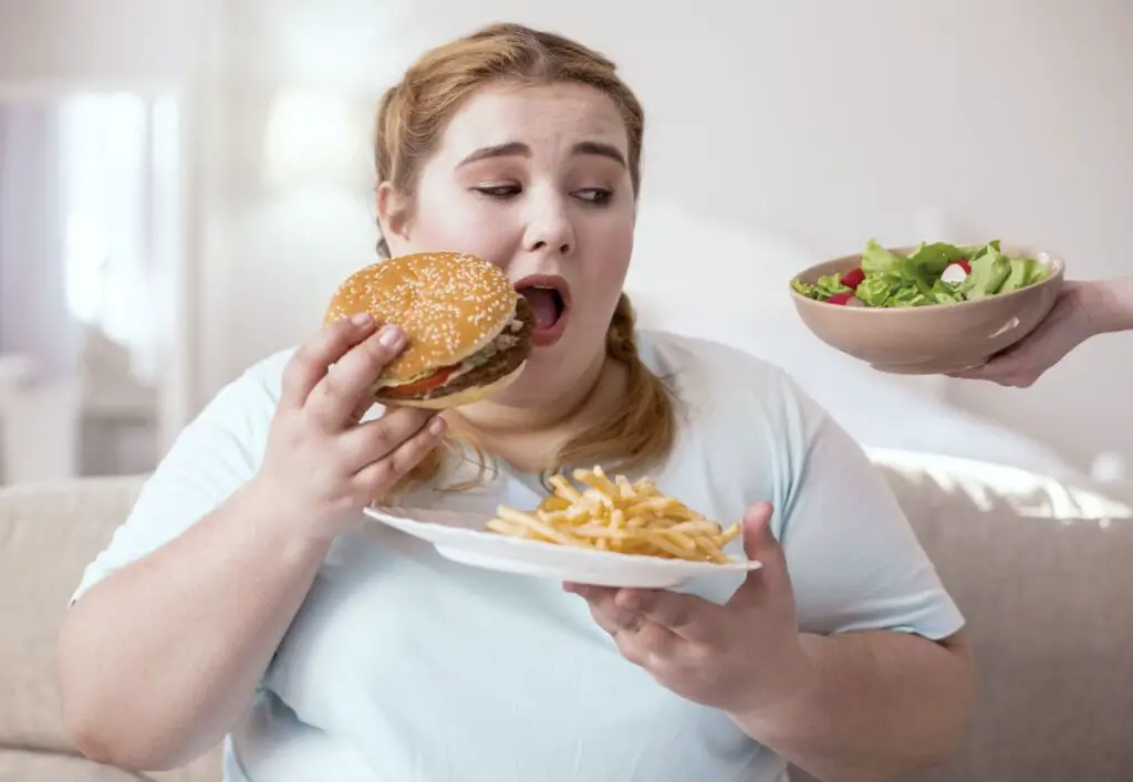 A woman eating an Ultra-Processed Foods