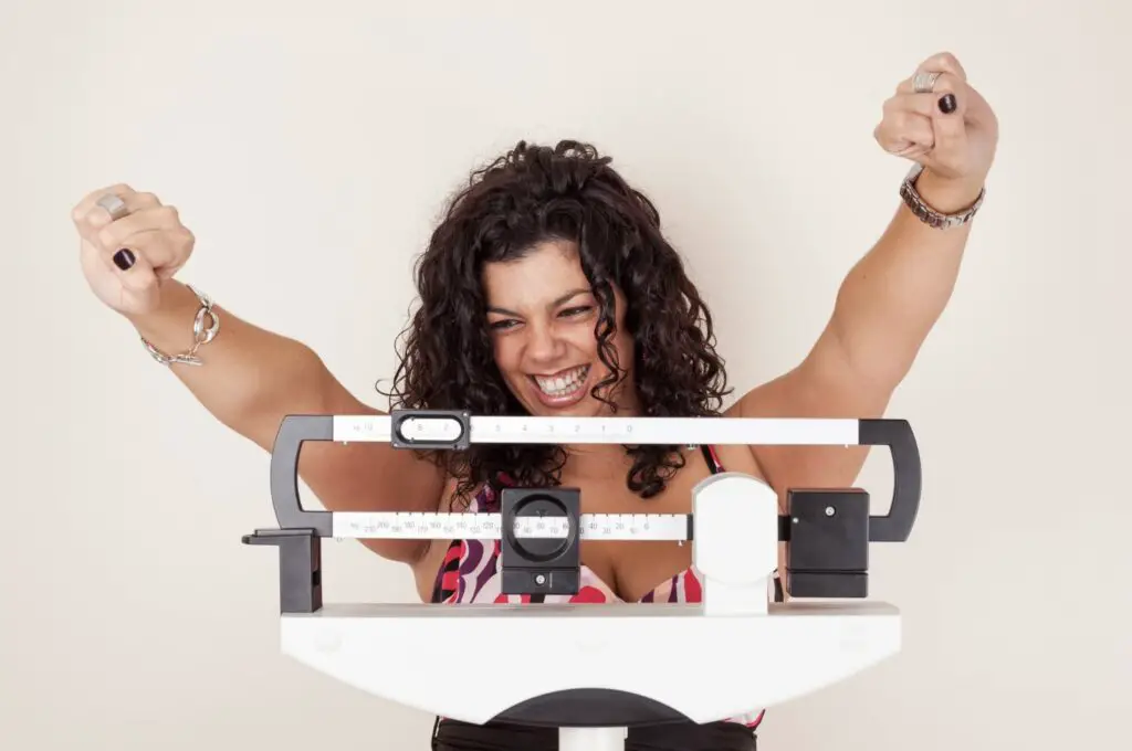 A girl was so happy because she achieve her weight loss goal