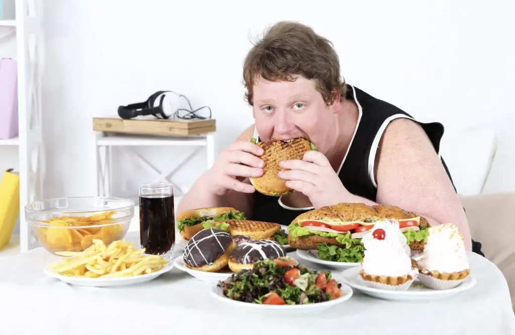 A man eating an unhealthy foods