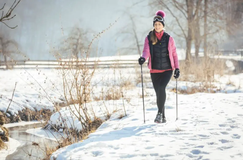 A woman doing a nordic walking in snow